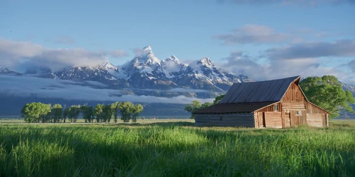 Grand Teton barns and mountains during a cloudy summer morning