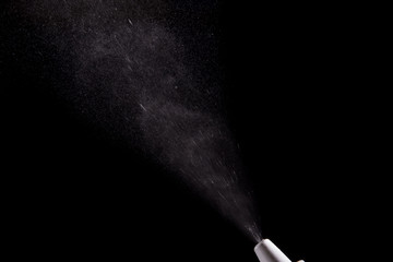 Spray for nose sprayed in the air on a black background