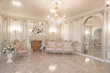 daylight in the interior and light of electric lamps. Morning in luxurious light interior in...