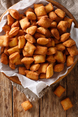 Chin Chin – West African Fried pastry enjoyed throughout the region especially in Nigeria - Crispy Crunchy and Addictive closeup in a bowl. Vertical top view