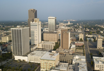 A Square aerial composition of downtown Little Rock buildings with the State Capitol Building...