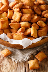 Chin Chin – West African Fried pastry enjoyed throughout the region especially in Nigeria - Crispy Crunchy and Addictive closeup in a bowl. Vertical