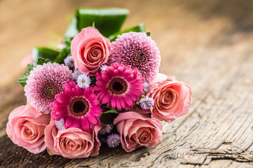 Close-up beautiful bouquet of flowers on wooden table.