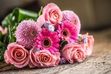 Close-up beautiful bouquet of flowers on wooden table.