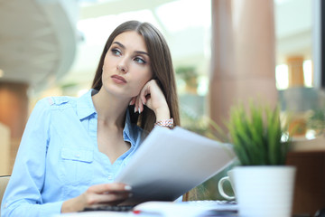 Fototapeta premium Concentrated business lady comparing documents at office.