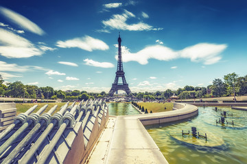 Trocadero Fountains and the Eiffel tower on a summer day with dramatic sky. Travel background.