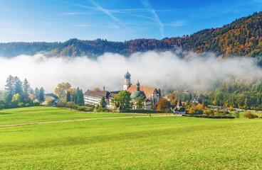 Scenic foggy mountain landscape with an old monastery in Black Forest, Germany. Colorful travel...