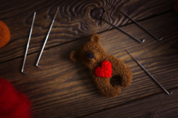 toy bear with heart from wool for dry felting
