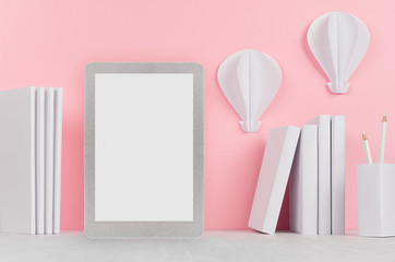Fashion trendy office desk - white stationery, blank tablet touch computer and decorative origami aerostats on soft light pink background.