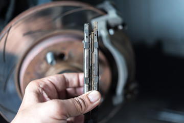 Disc brake and asbestos brake pads at car garage