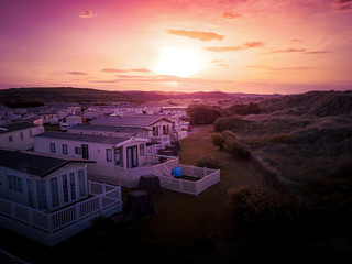 Sun Setting over the sea and Caravan and camping park, static home aerial view. Porthmadog holiday...