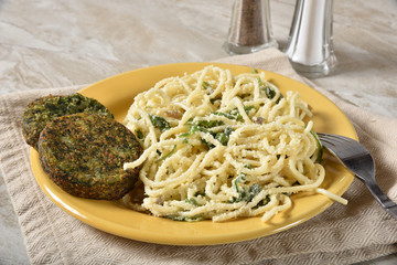 Healthy spinach cakes and pasta salad