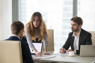 Mad female worker talking to company CEO proving point of view, showing mistake in agreement or...
