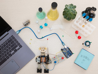 A metal robot and an electronic board that can be programmed. Robotics and electronics. Laboratory...