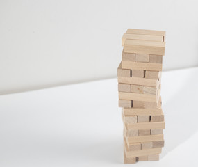 Jenga tower collapses on the white background