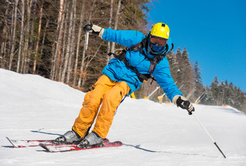 Fototapeta na wymiar Low angle shot of a professional skier skiing on the slope recreation active sport seasonal resort sportspeople adrenaline extreme concept