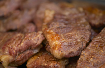 PILE OF FRESHLY COOKED BEEF STEAKS
