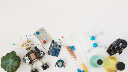 A metal robot and an electronic board that can be programmed. Robotics and electronics. Laboratory in the school. Mathematics, engineering, science, technology, computer code. STEM education for kid. 