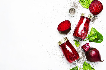 Delicious beetroot smoothies in glass bottles with chia on white food background, top view - obrazy, fototapety, plakaty