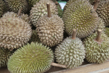 Close-up of durian fruits lying on a market stall table