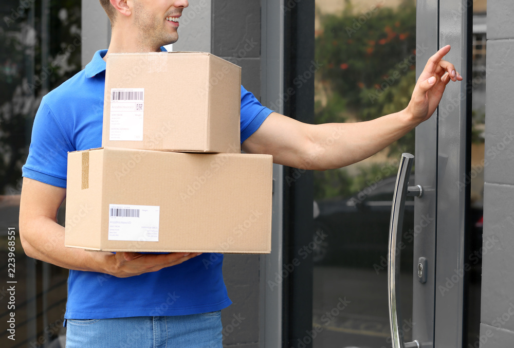 Poster Delivery service courier with parcels in hands ringing doorbell outdoors