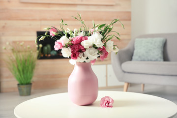 Obraz na płótnie Canvas Vase with beautiful flowers on table in living room, space for text