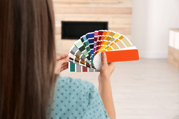 Female interior designer with color palette samples indoors