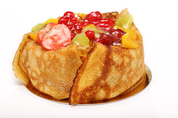 Pancake cake with fresh fruits on white background