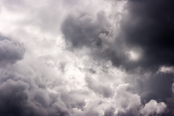 dark storm cloud on sunny summer day