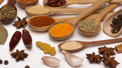 Spice. Spice in a wooden spoon. Herbs. Curry, saffron, turmeric, pepper and other isolated on white background.