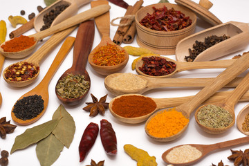 Spice. Spice in a wooden spoon. Herbs. Curry, saffron, turmeric, pepper and other isolated on white background.