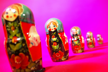 RUSSIAN DOLLS ON RED PINK BACKGROUND