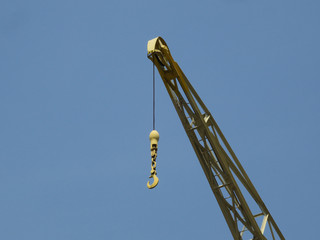 hook of a yellow crane in the harbor of Antwerp