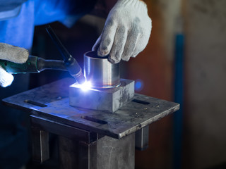 Men's hands with argon welding machine.  repair pipe stainless argon welding industrial construction