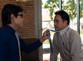Photo of two Asian businessmen quarrel facing each other. Business problem and Conflict concept..