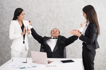 Fototapeta premium Celebrating success Cheerful young people looking excited. Successful entrepreneurs and business people achieving goals