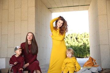 beautiful mothers with children in clothes in style family look	