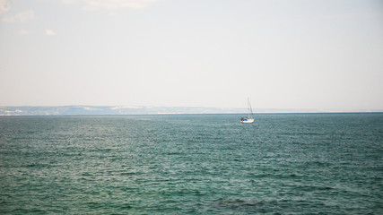 Boat out in of the harbor in deep waters. Sailing skills of humans