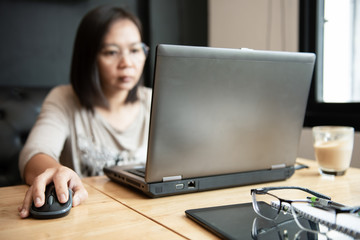 Asian girl office worker using laptop in office.