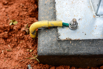 Install ground wire cable at the concrete base.