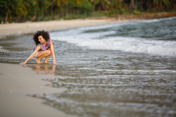 Mixed race woman on a tropical beach.