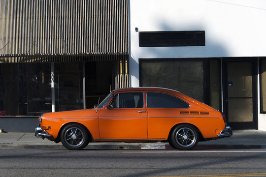 Side View Of A Classic Vintage Orange Car In The Street In LA