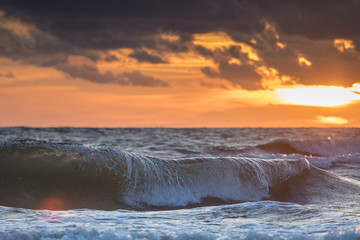 Sea wave and sunset