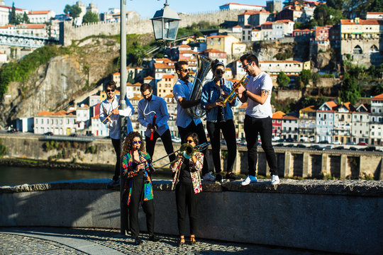 Group of musicians (Jazz band) play music in the street of old Porto downtown, Portugal.