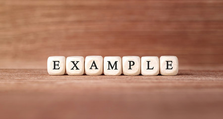 Word EXAMPLE made with wood building blocks