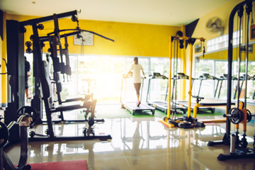 Fototapeta na wymiar Blur the gym with exercise equipment and light in the morning.
