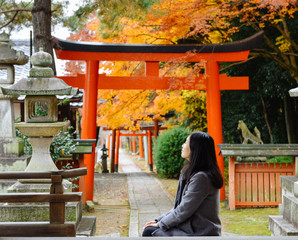 Single Asian girl enjoying autumn maple foliage in Japanese temple, Kyoton, Kyoto, Japan