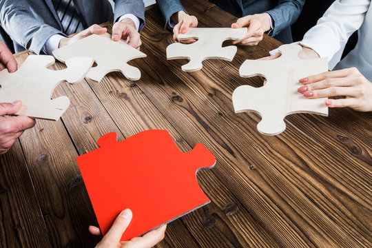 Business people assembling jigsaw puzzle