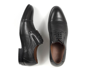 Classic male black leather shoes isolated on a white, top view