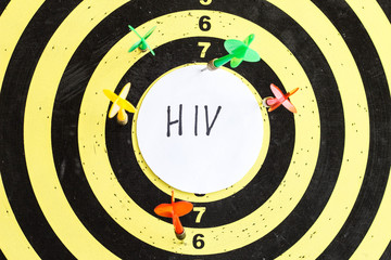 Target with darts in the center of which the inscription HIV